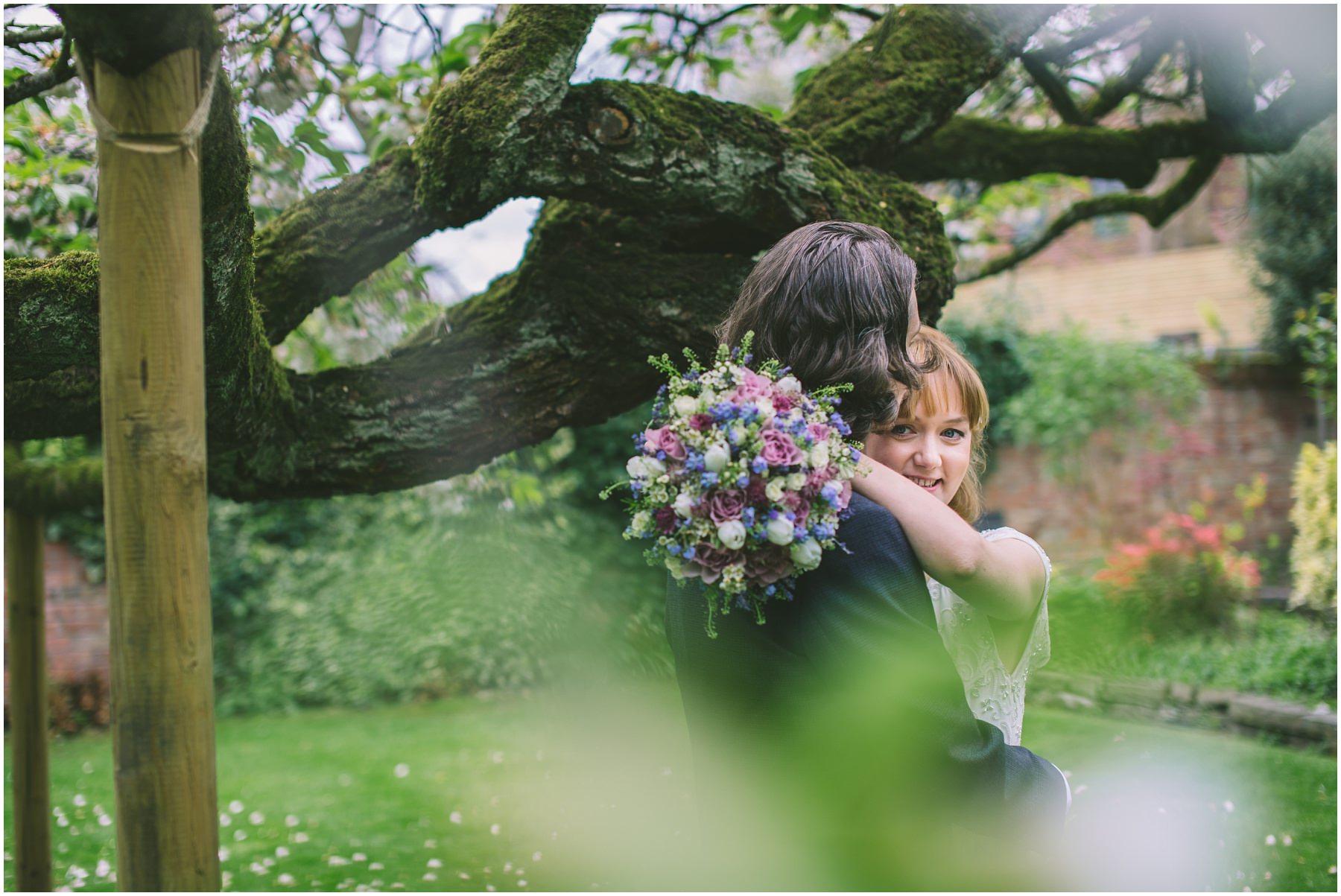 Bride and Groom share a moment under the tree at Eleven Didsbury Park