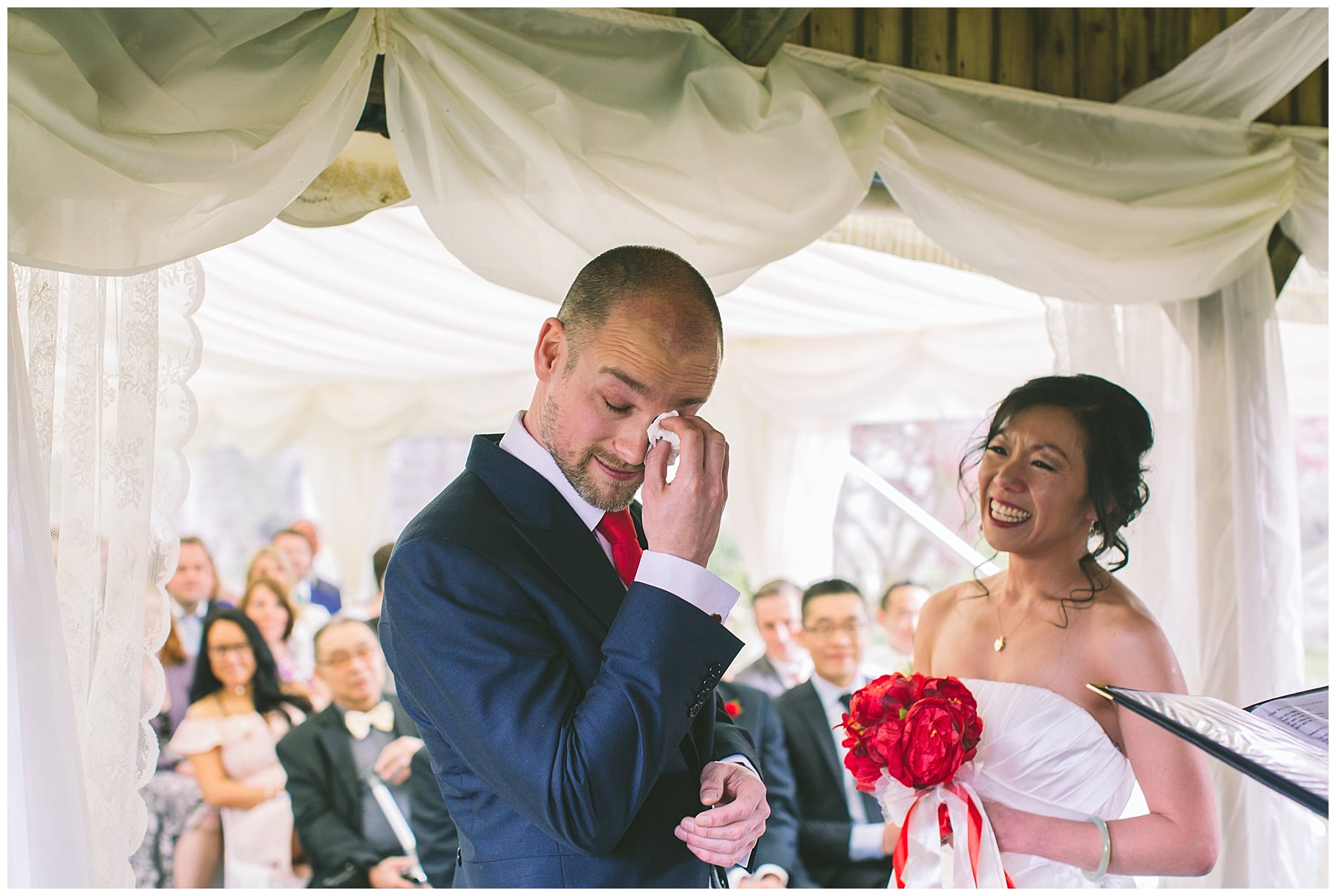 Groom wipes away a tear during wedding ceremony