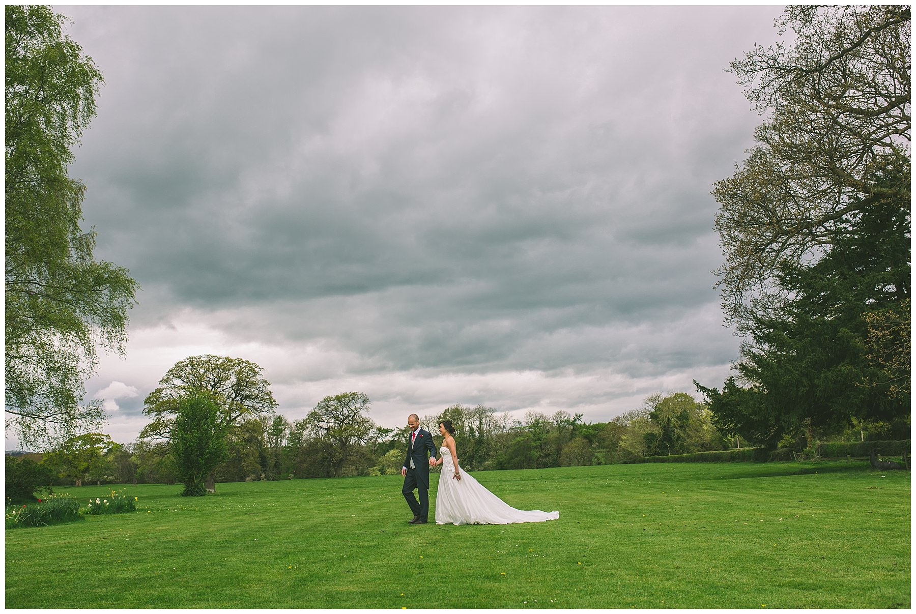 Newlyweds take a stoll over the lawns at Pentre Mawr