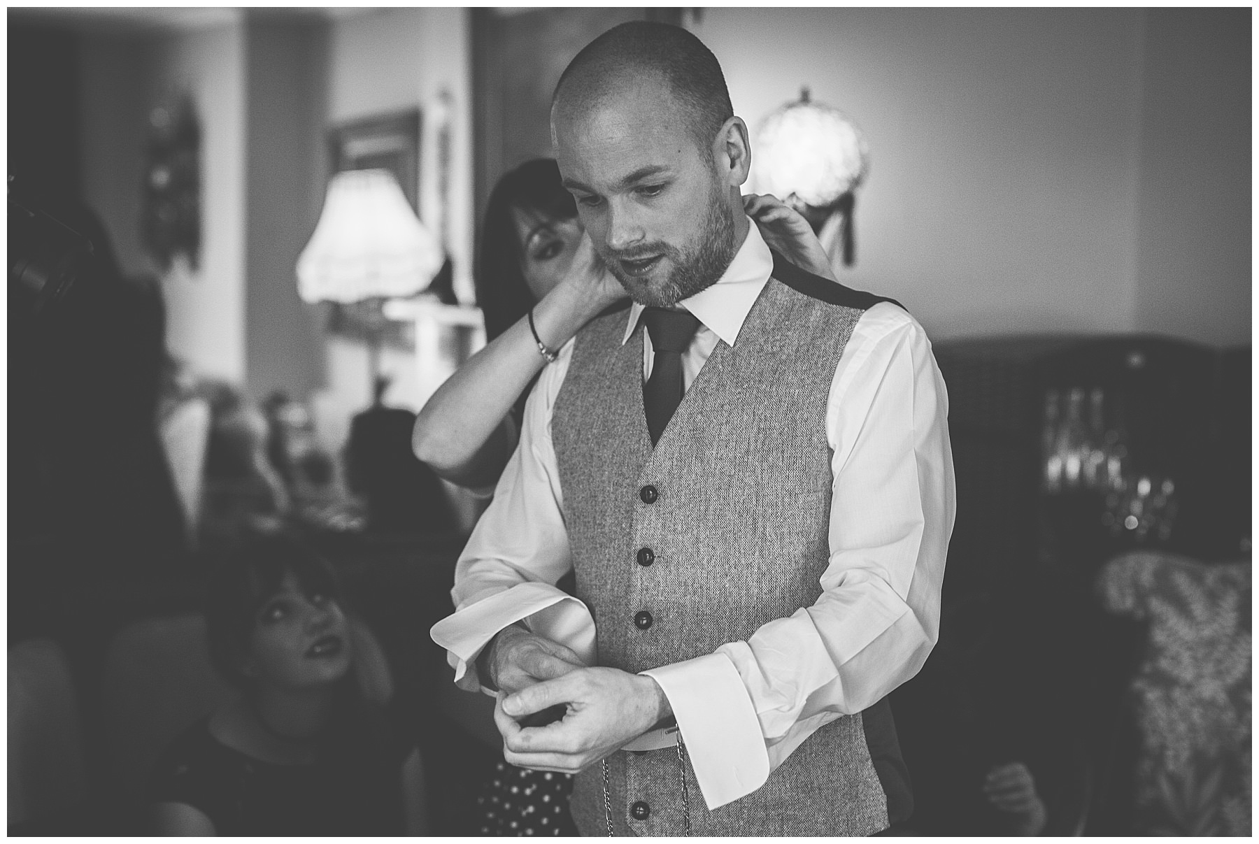 Groom applies his finishing touches before the wedding
