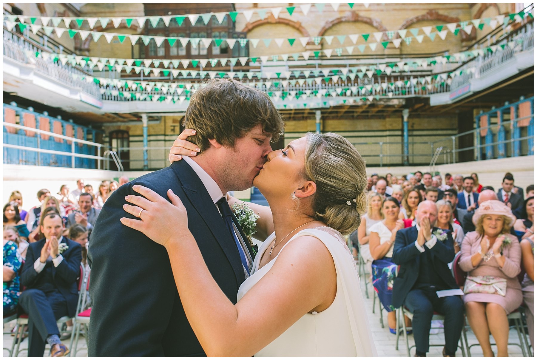 First kiss under the bunting in the pool at Victoria Baths
