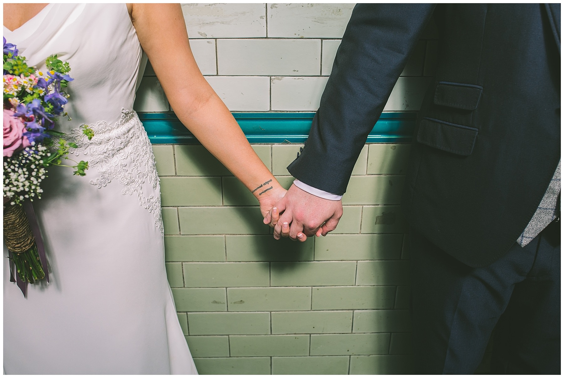 Bride and Groom hold hands at Victoria Baths
