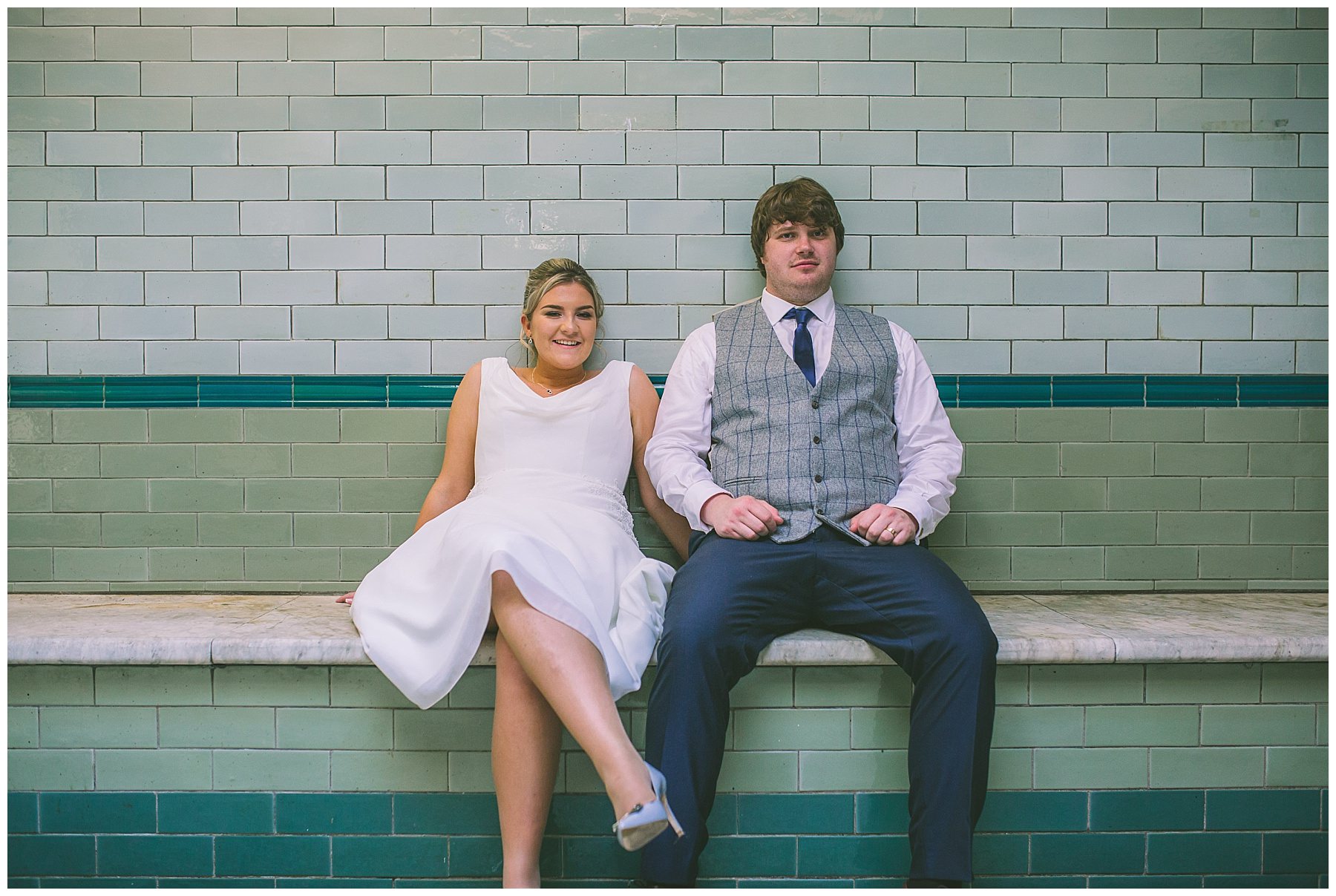 Bride and Groom take a seat to cool down at Victoria Baths