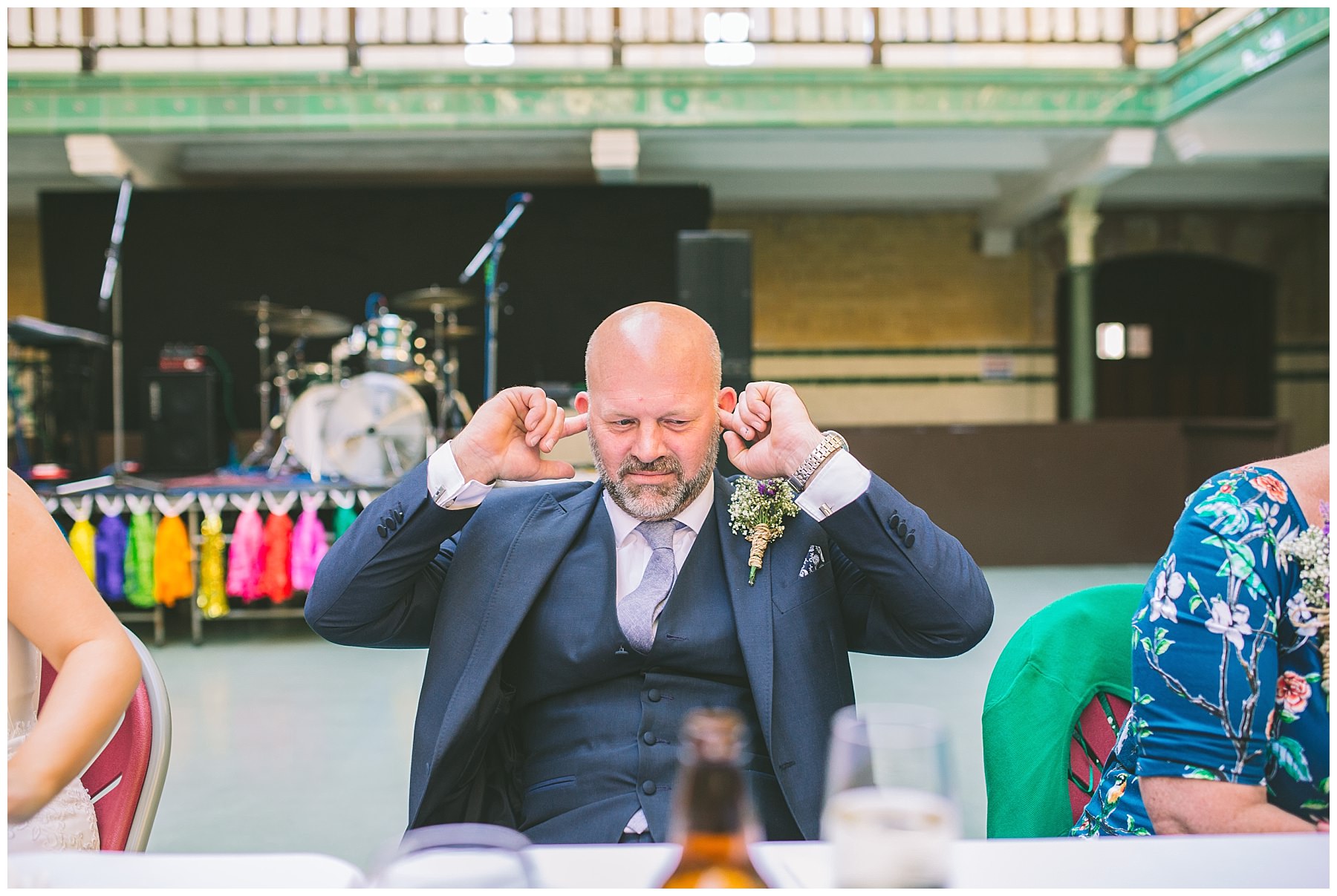 Brides father plugs his ears during the grooms speech at Victoria Baths