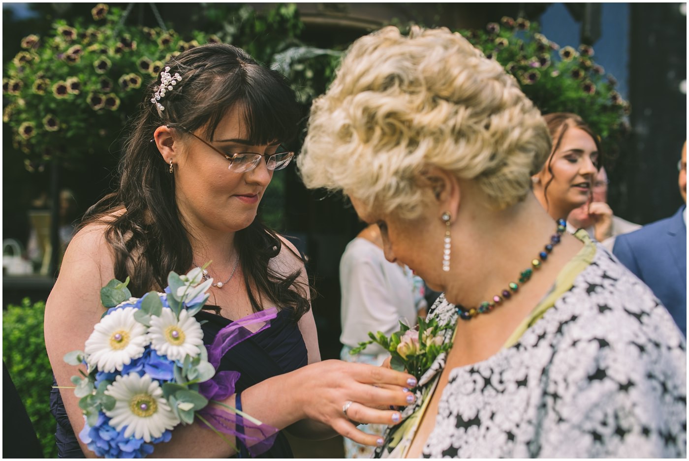 button hole being applied by a bridesmaid