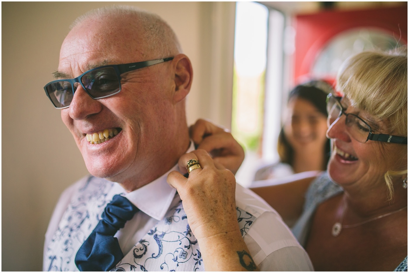 Father of the bride has his cravat fixed