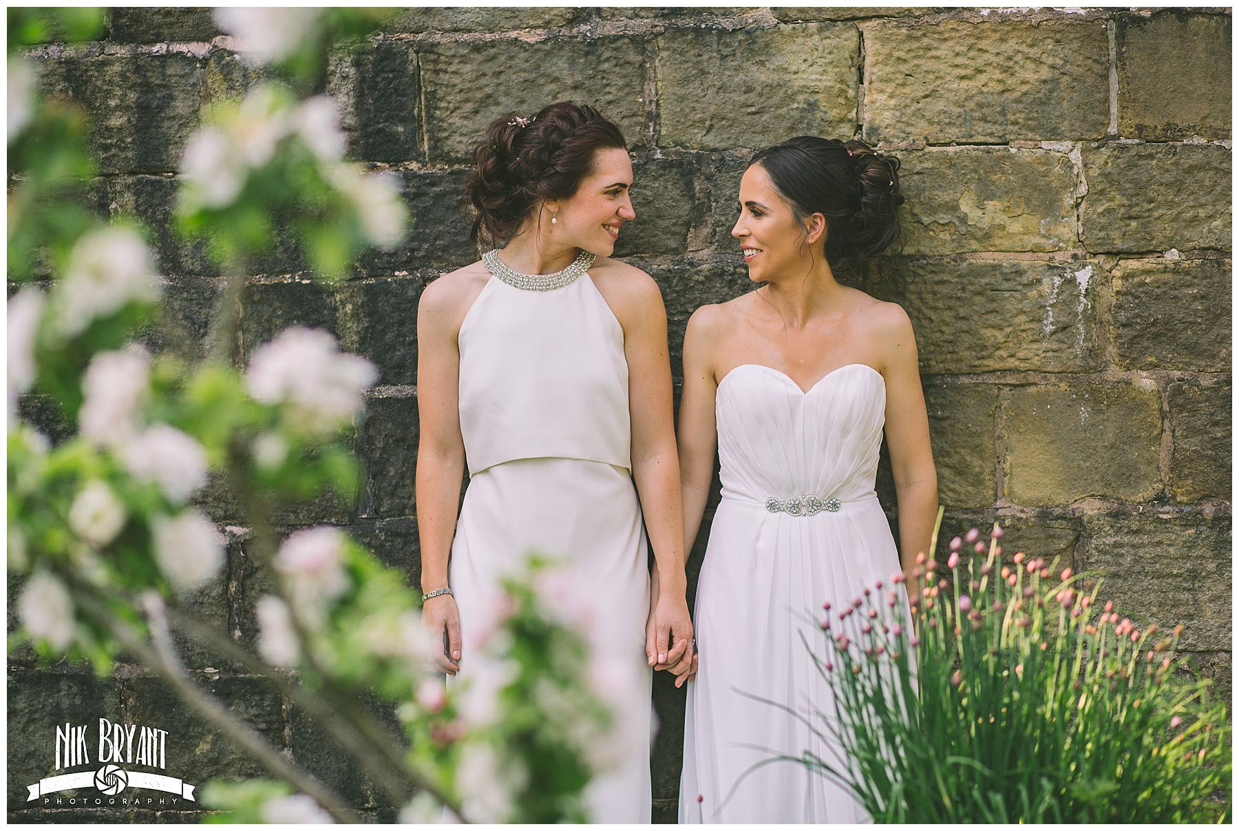 two brides stand hand in hand for couples portraits at Lancashire Wedding