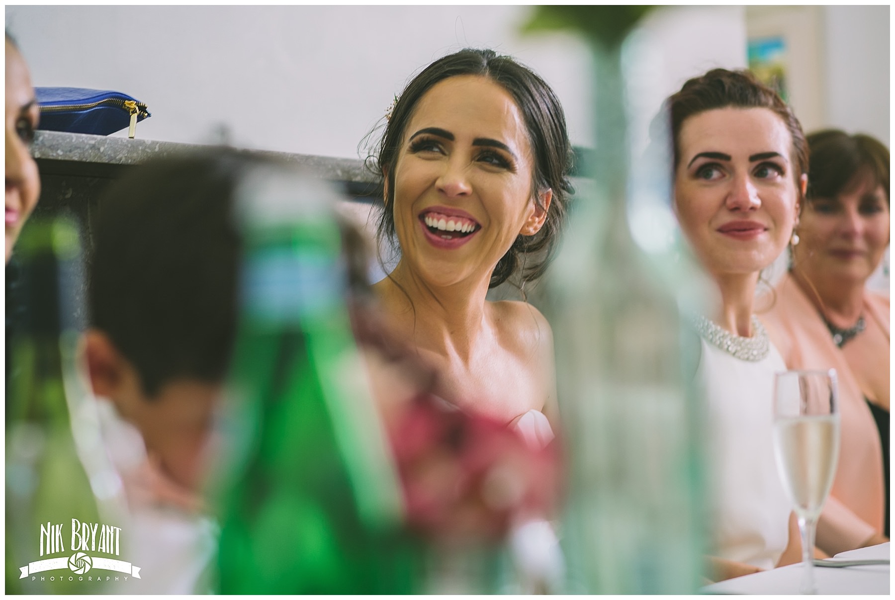 bride laughs during the speeches