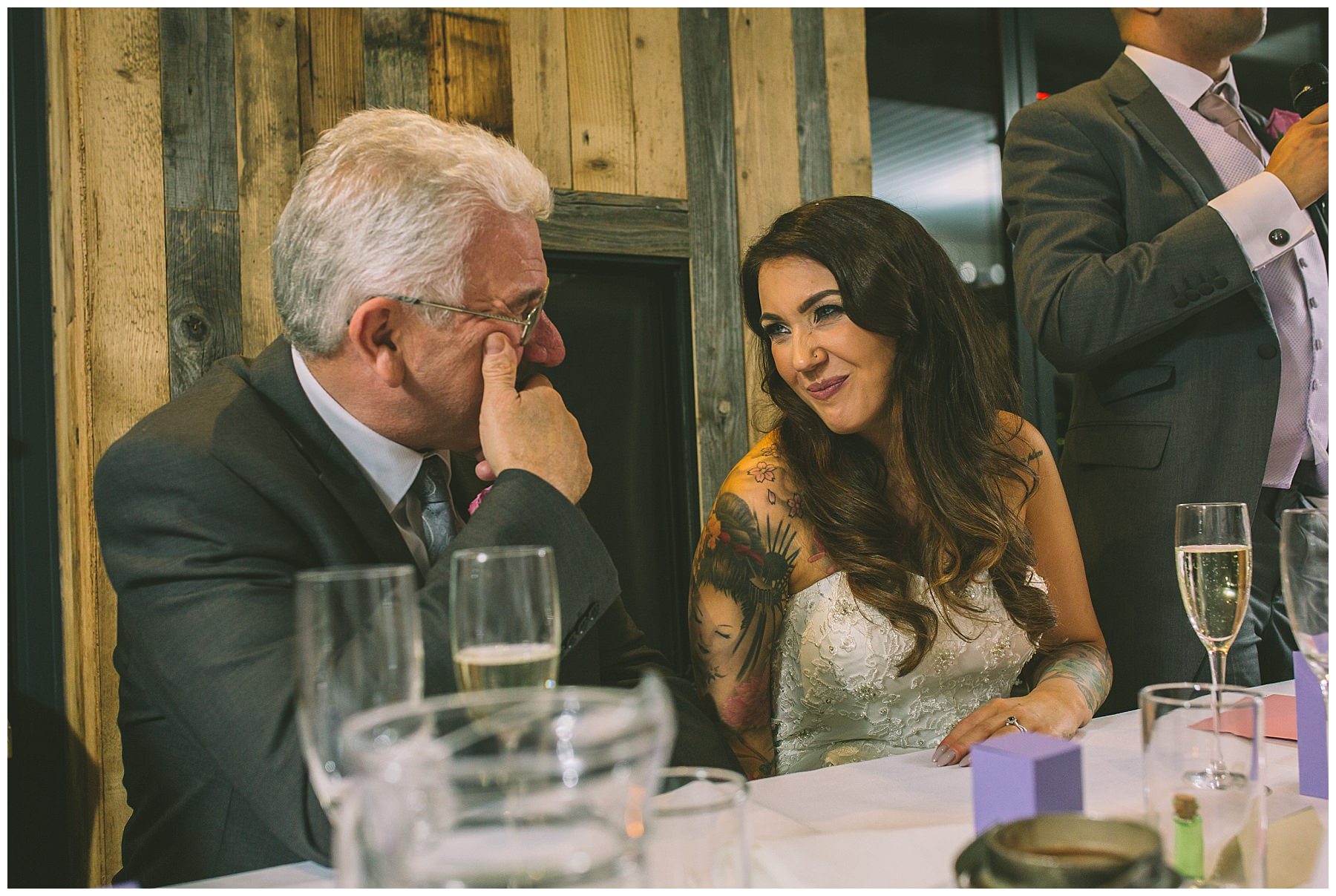 Bride and father share a moment during speeches