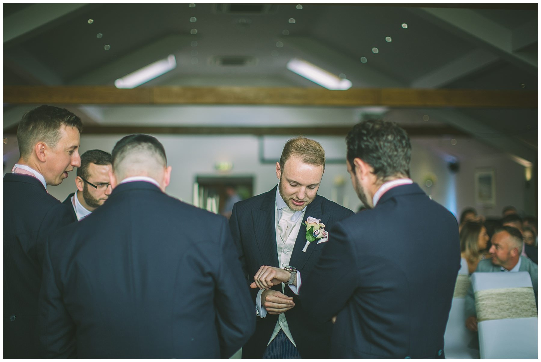 Groom checks his watch as he waits for his bride at The Fishermans Retreat