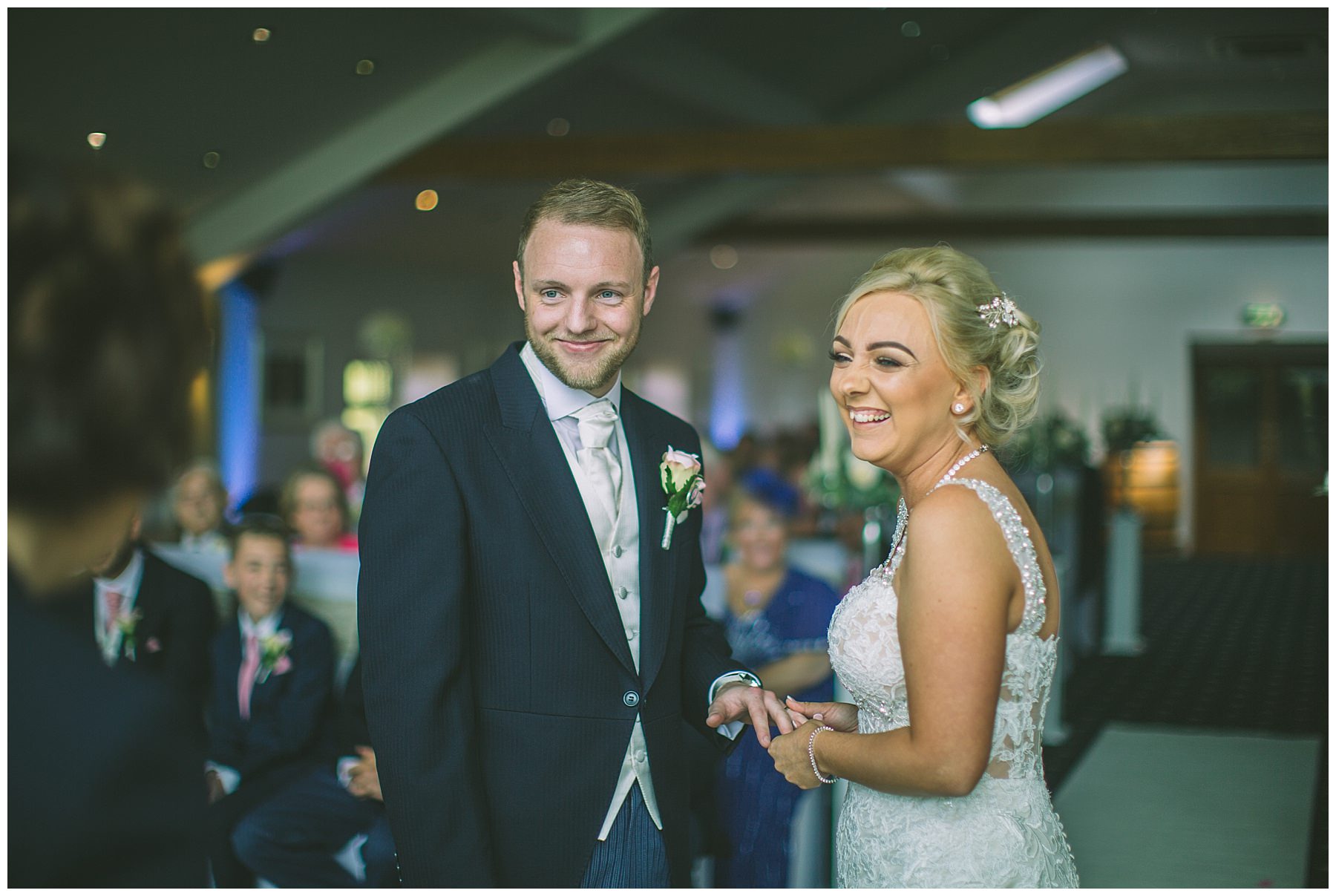 Bride and Groom smile during wedding ceremony in Ramsbottom