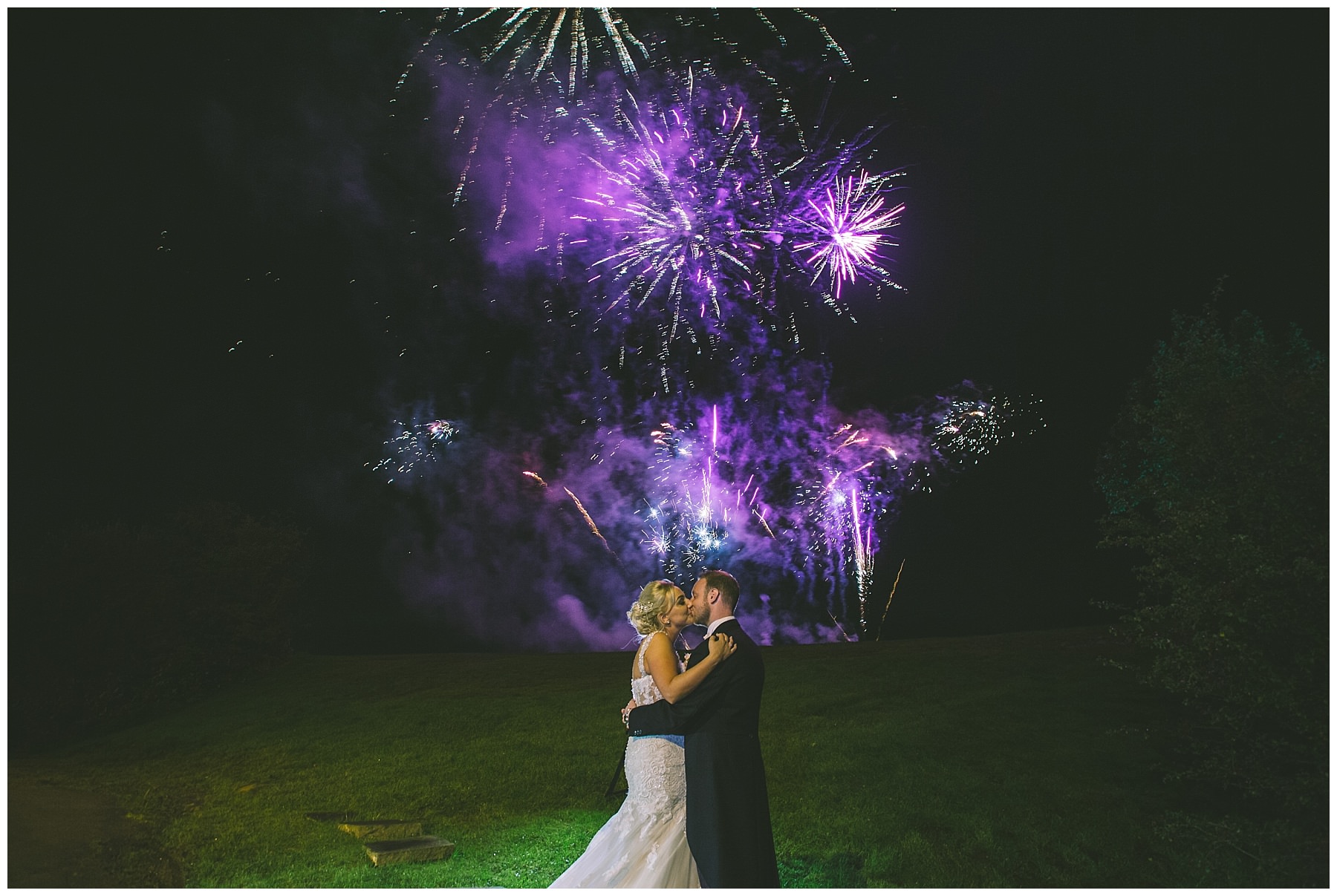 Bride and Groom kiss amongst the fireworks