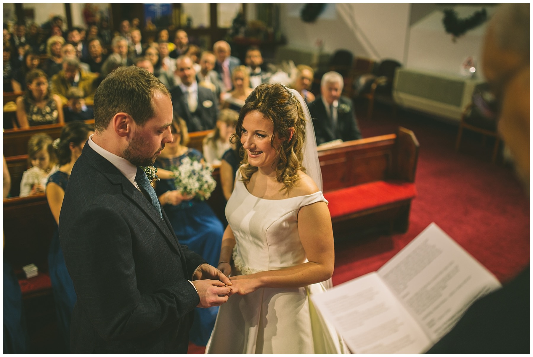 Bride and Groom exchange rings during church ceremony