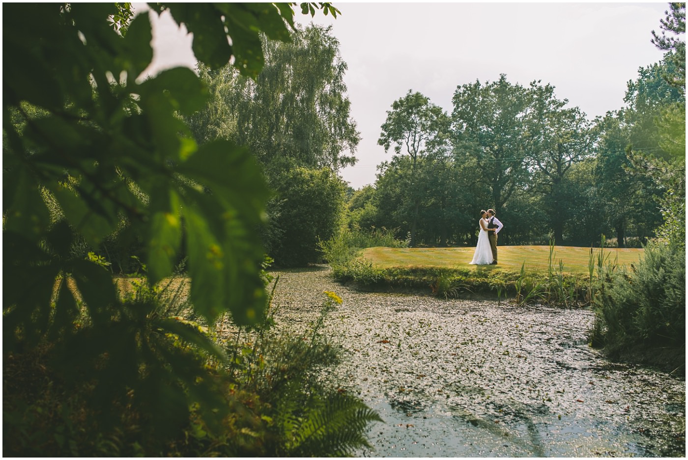 Couples portraits over the lake at the oaktree of peover wedding venue in cheshire