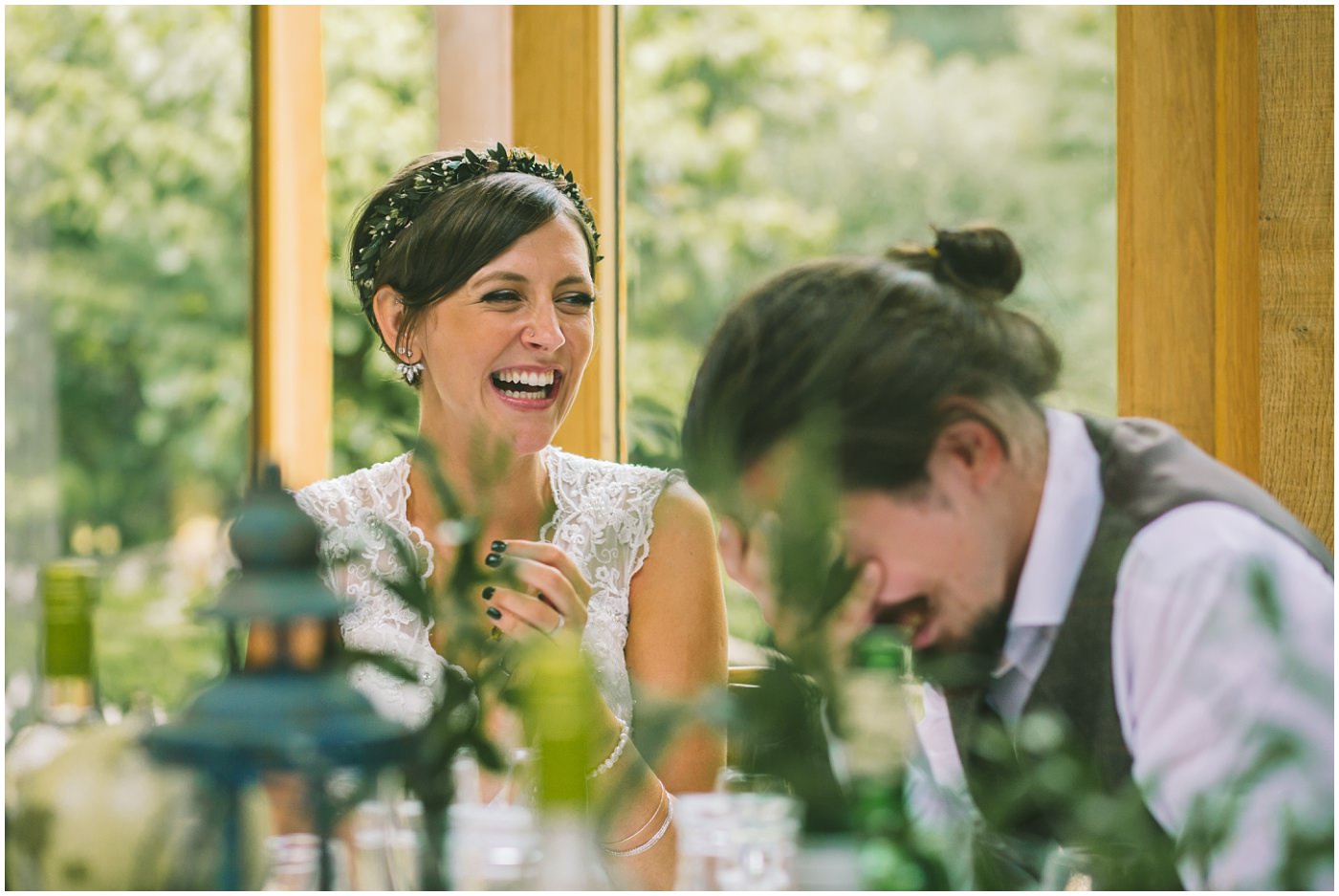 bride laughs as the groom hides his head in his hands