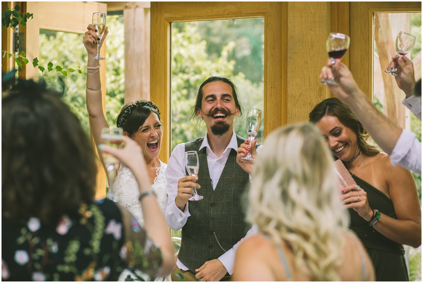bride and groom raise a glass in toast