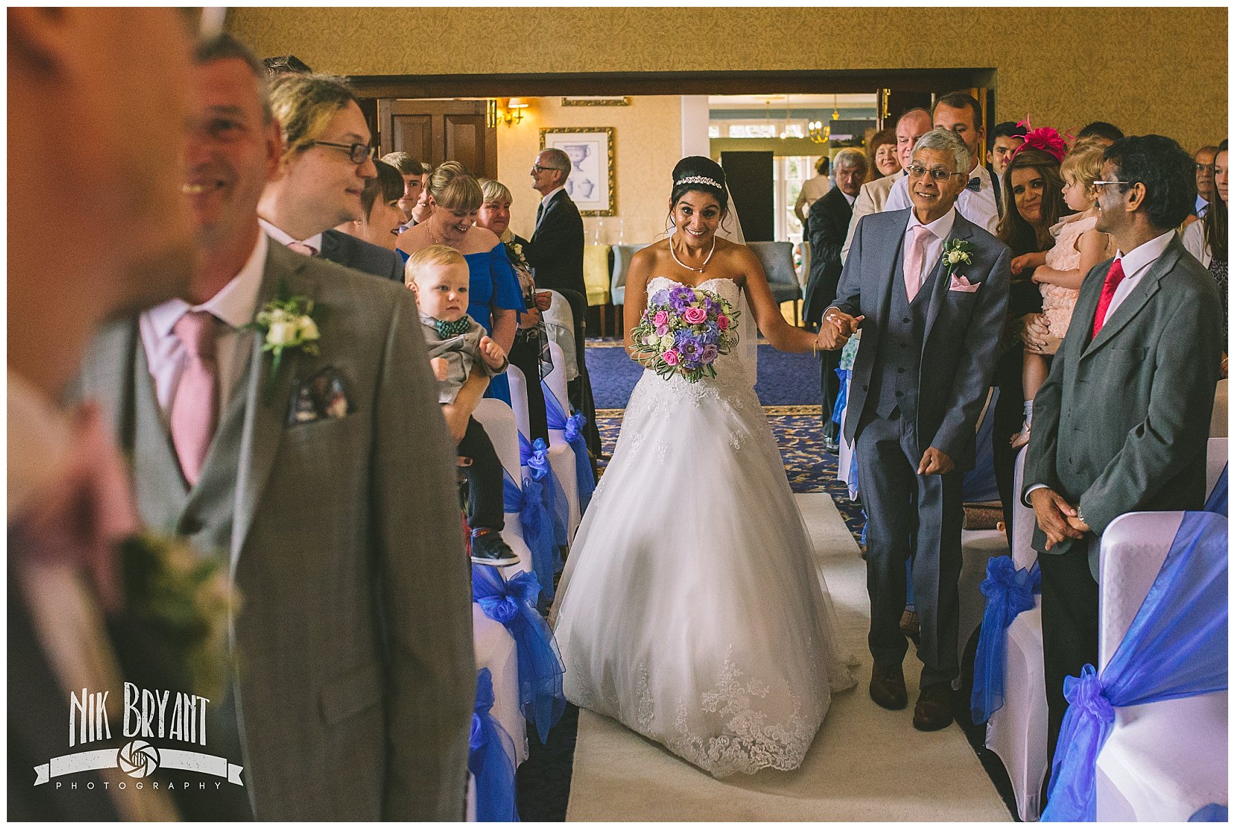 Bride walks down the isle hand in hand with her father