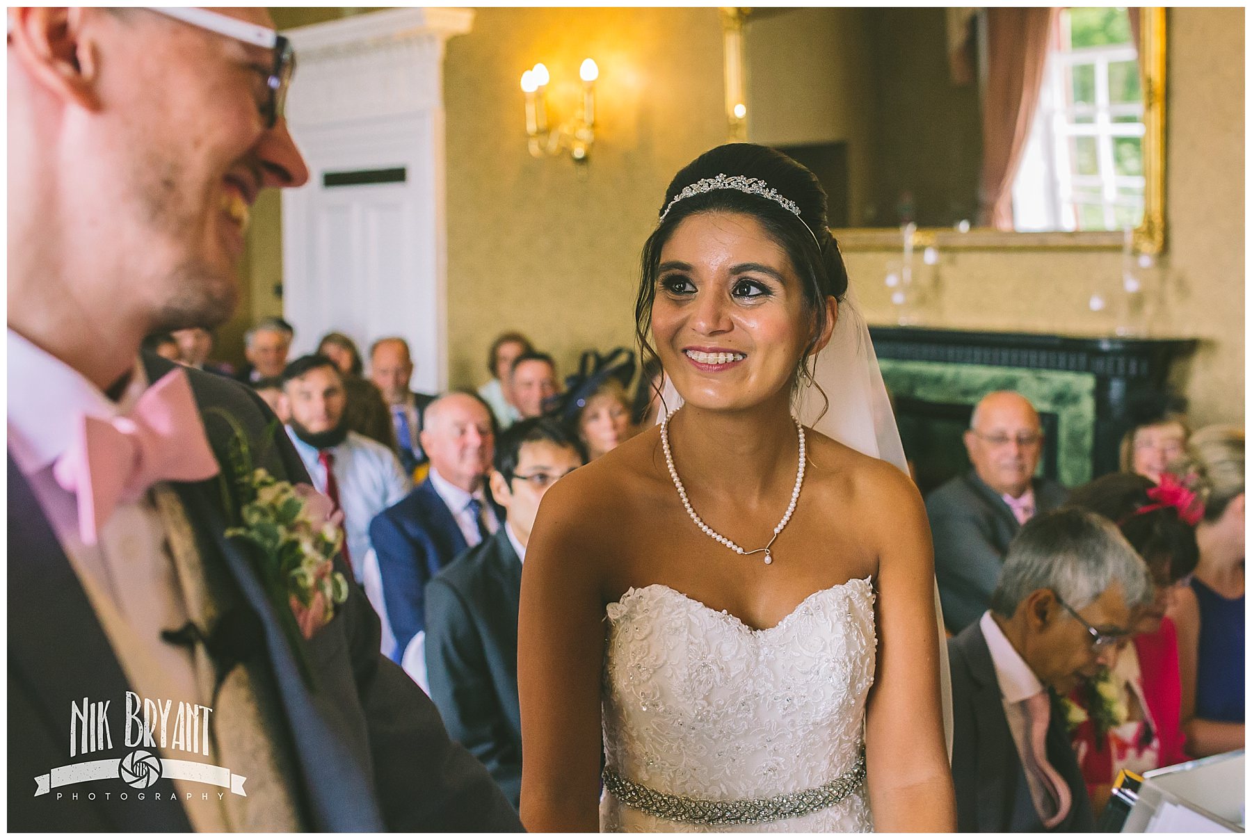 Bride smiles as she sees her groom for the first time