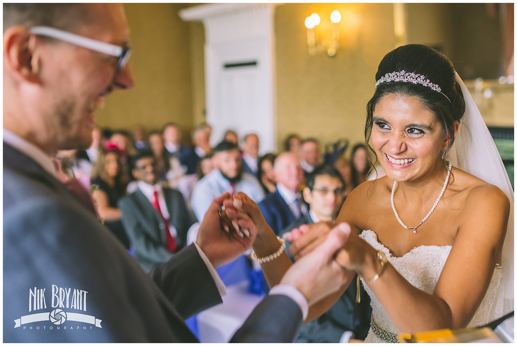 Bride smiles and laughs during shrigley hall wedding