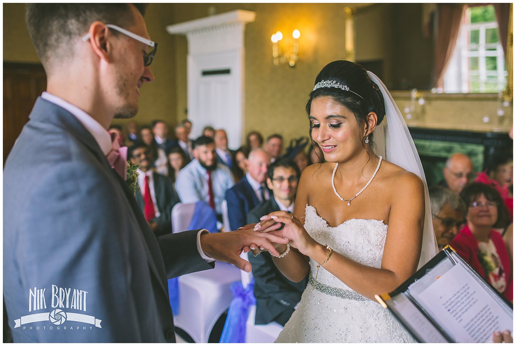 bride gives groom wedding ring during ceremony