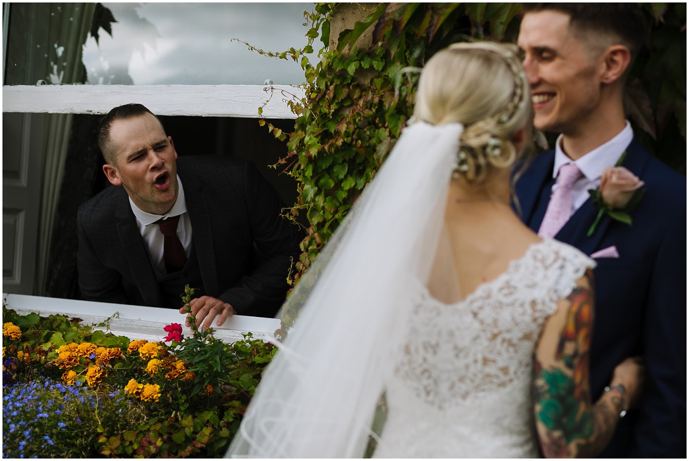 guest heckles bride and groom during portrait session