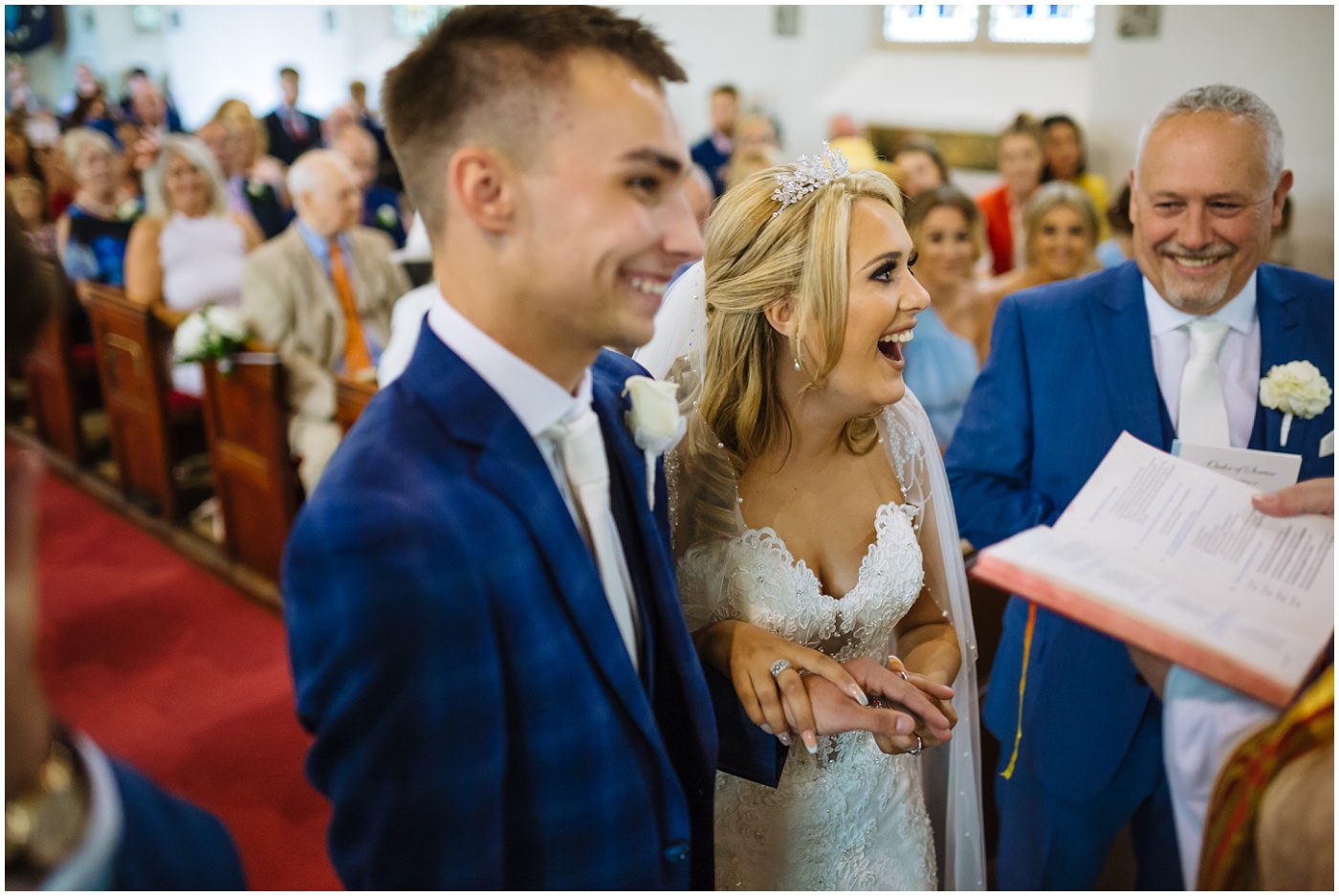 bride laughing during exchange of rings during church service