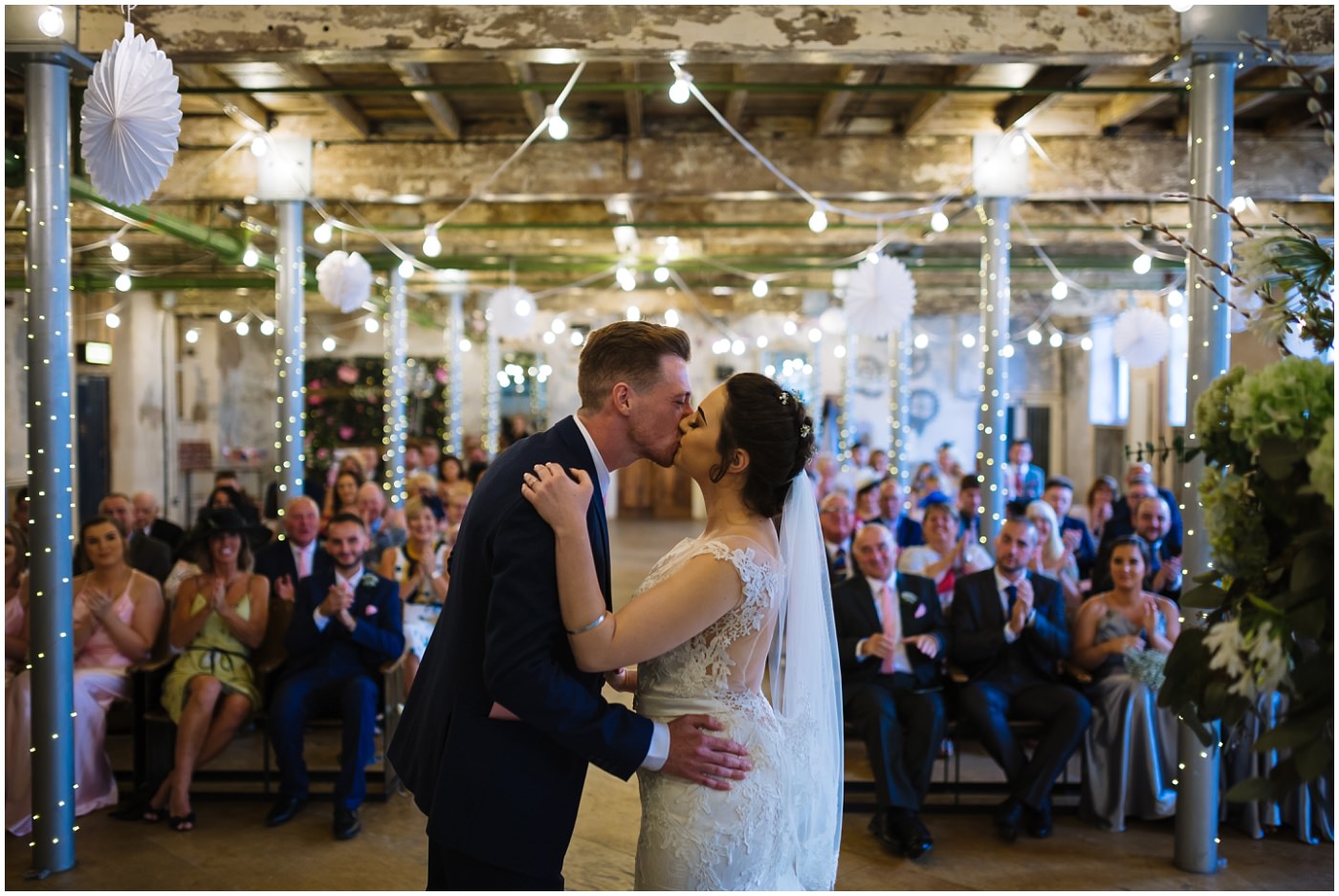 bride and groom first kiss at holmes mill wedding