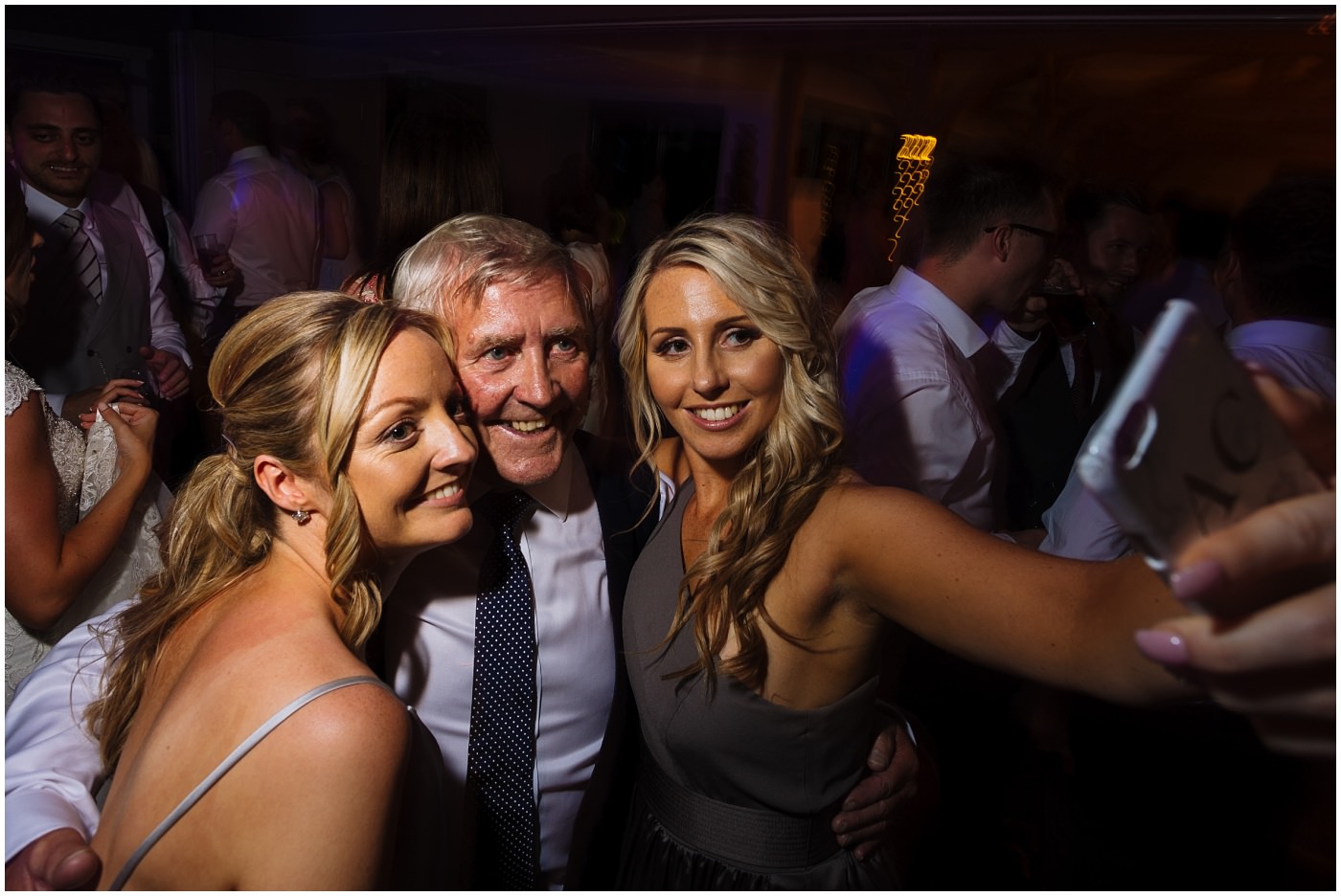 Two bridesmaids get a selfie with father of the bride at pryors hayes