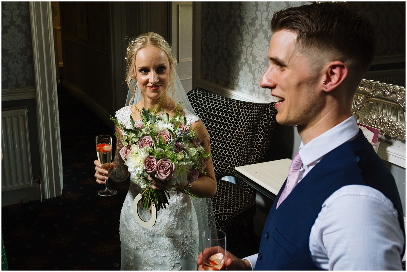 bride looks at groom during drinks reception