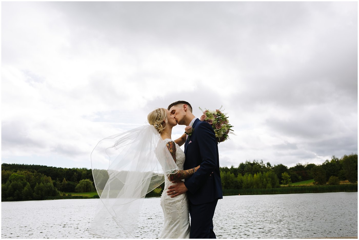 tattooed bride and groom on the lake at walton hall