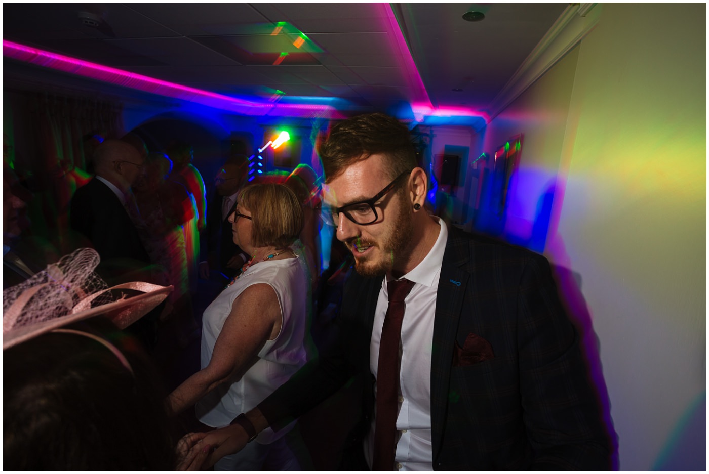 wedding guests fill the dance floor 