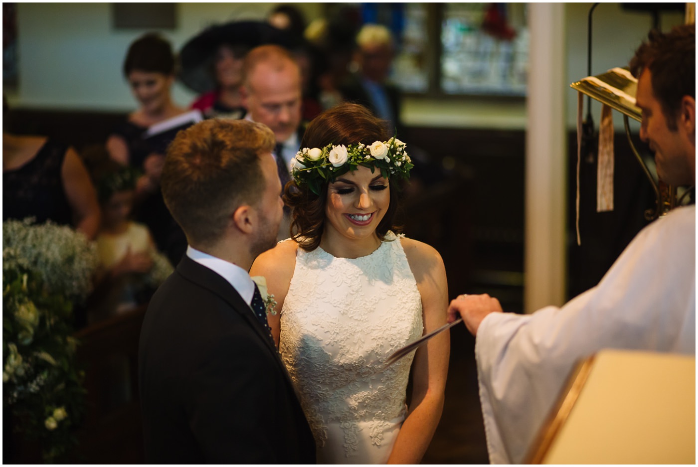 bride smiles during wedding service