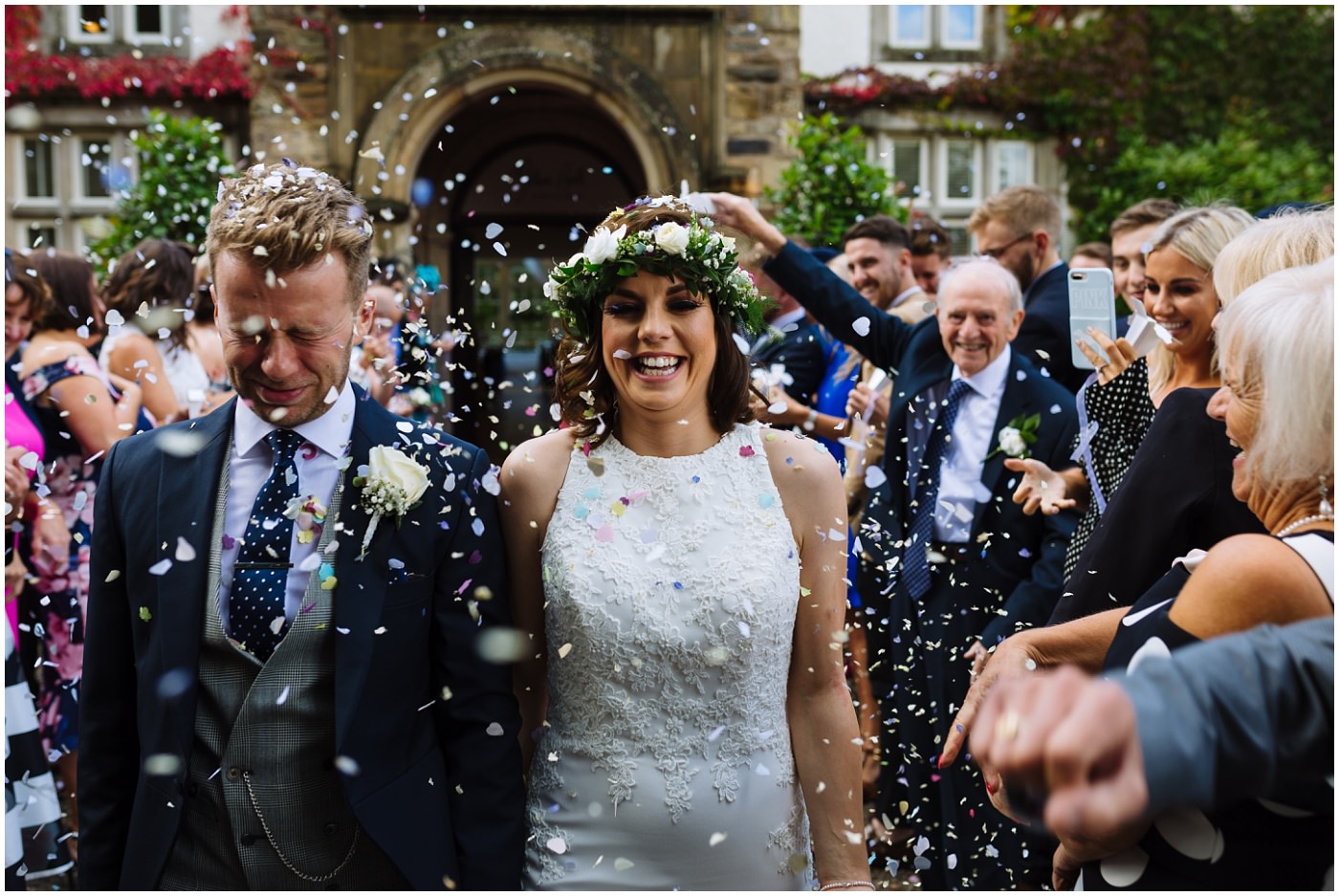 Bride and Groom walk through shower of confetti at mitton hall