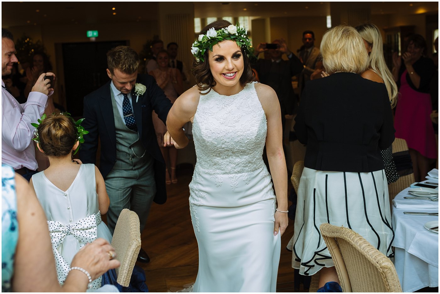 Bride leads Groom to top table 