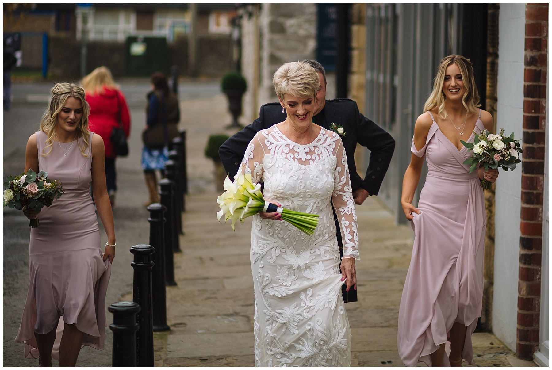 Bride and bridesmaids walk through holmes mill