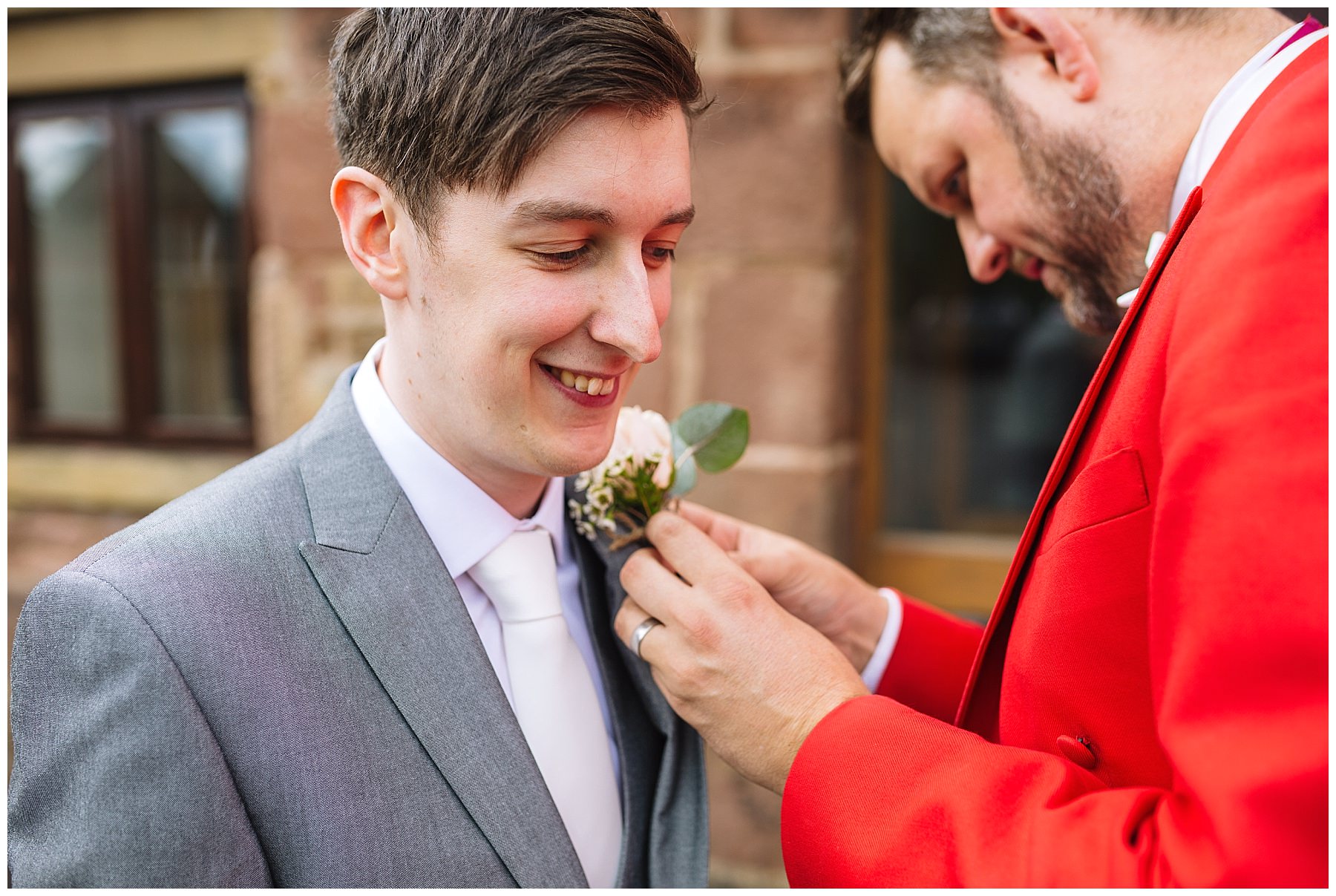 Toastmaster assists with grooms buttonhole