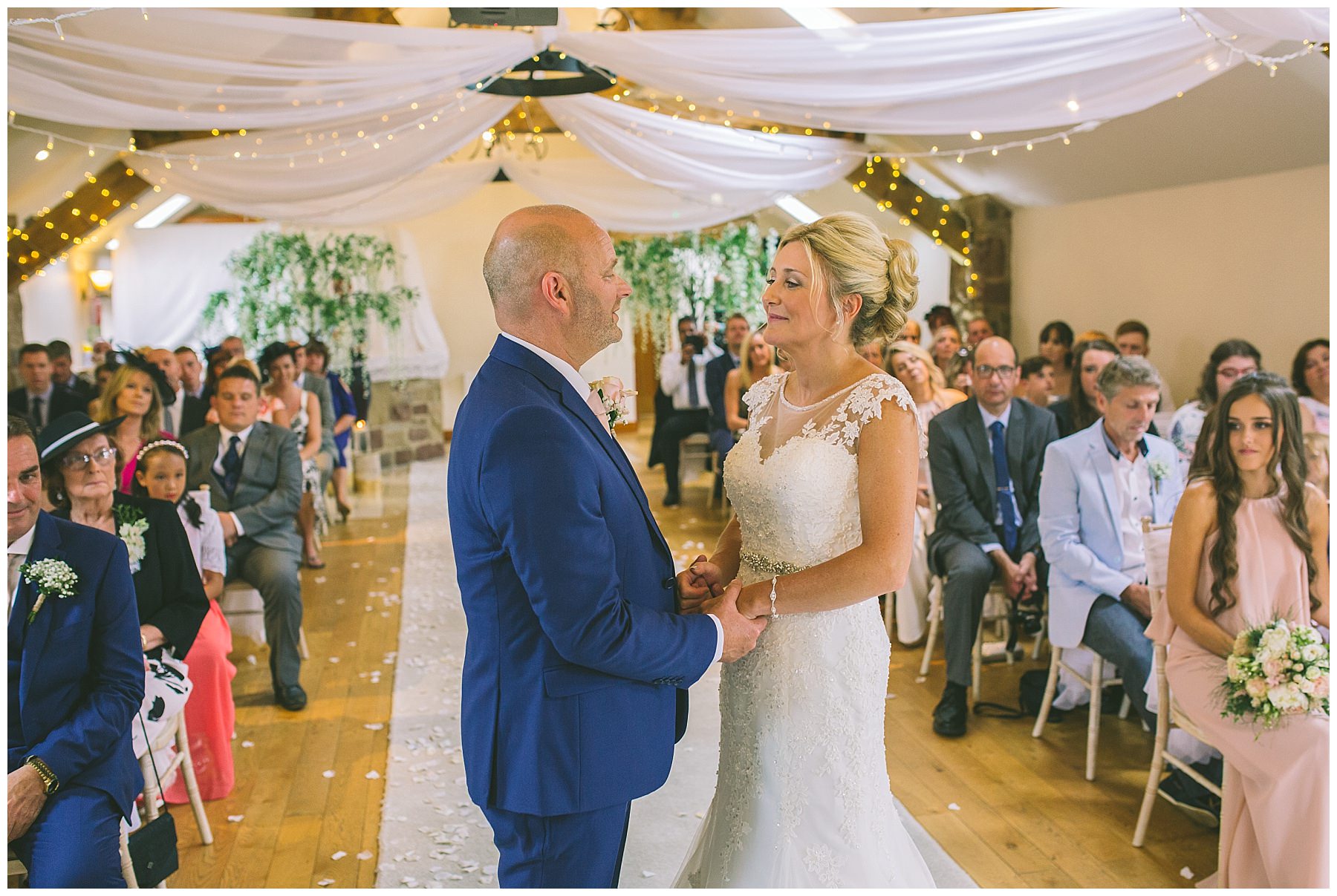 bride and groom hold hands during wedding ceremony at beeston manor