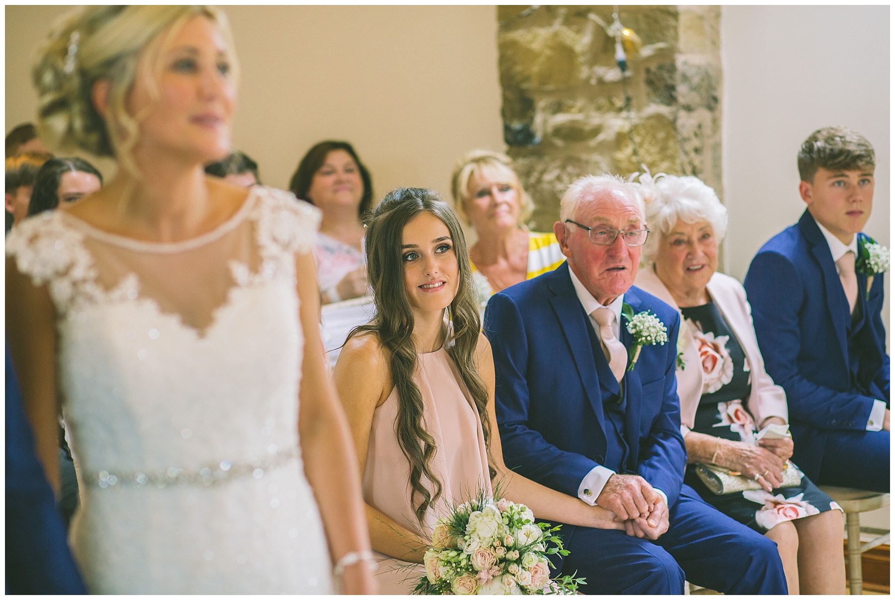 father of the bride holds grand daughters had during emotional wedding ceremony
