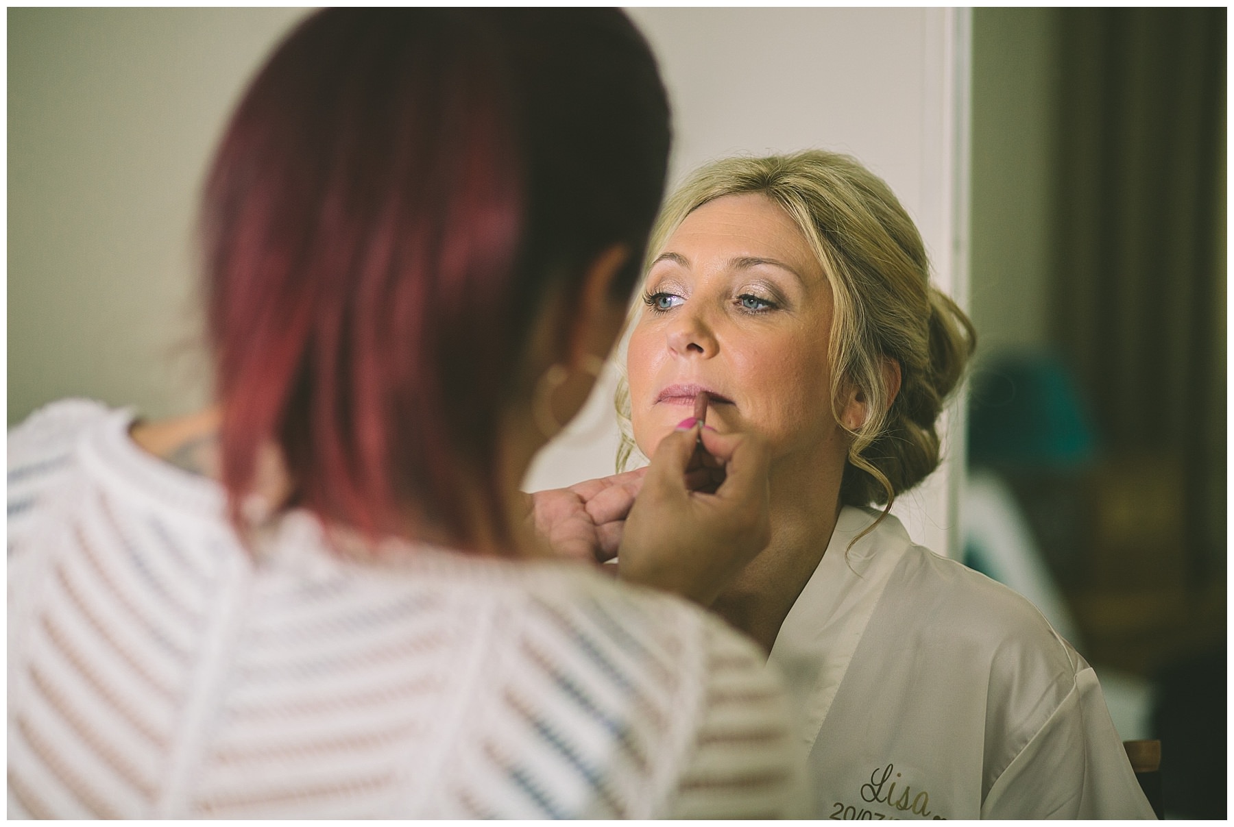 make up artist applies brides lip liner at beeston manor