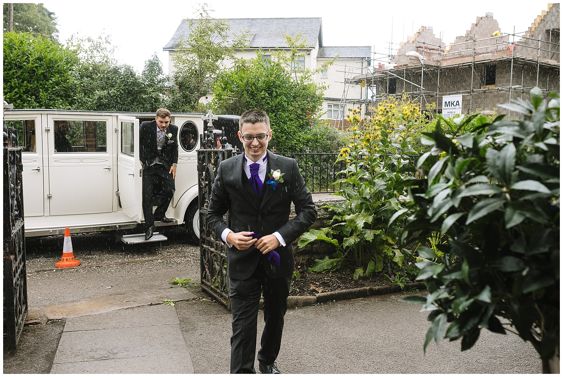 groom arrives at wigan church in the rain