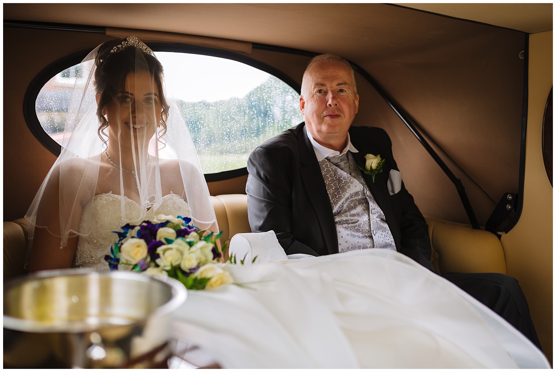 Bride and dad arrive in wedding car