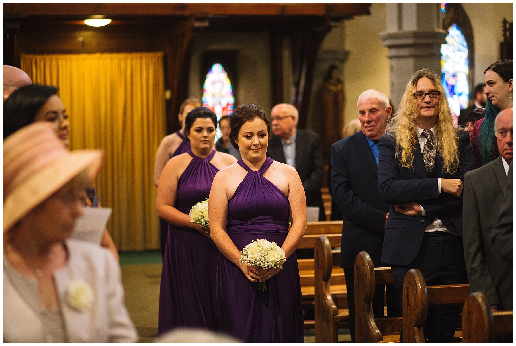 bridesmaids arrive into church for wedding ceremony