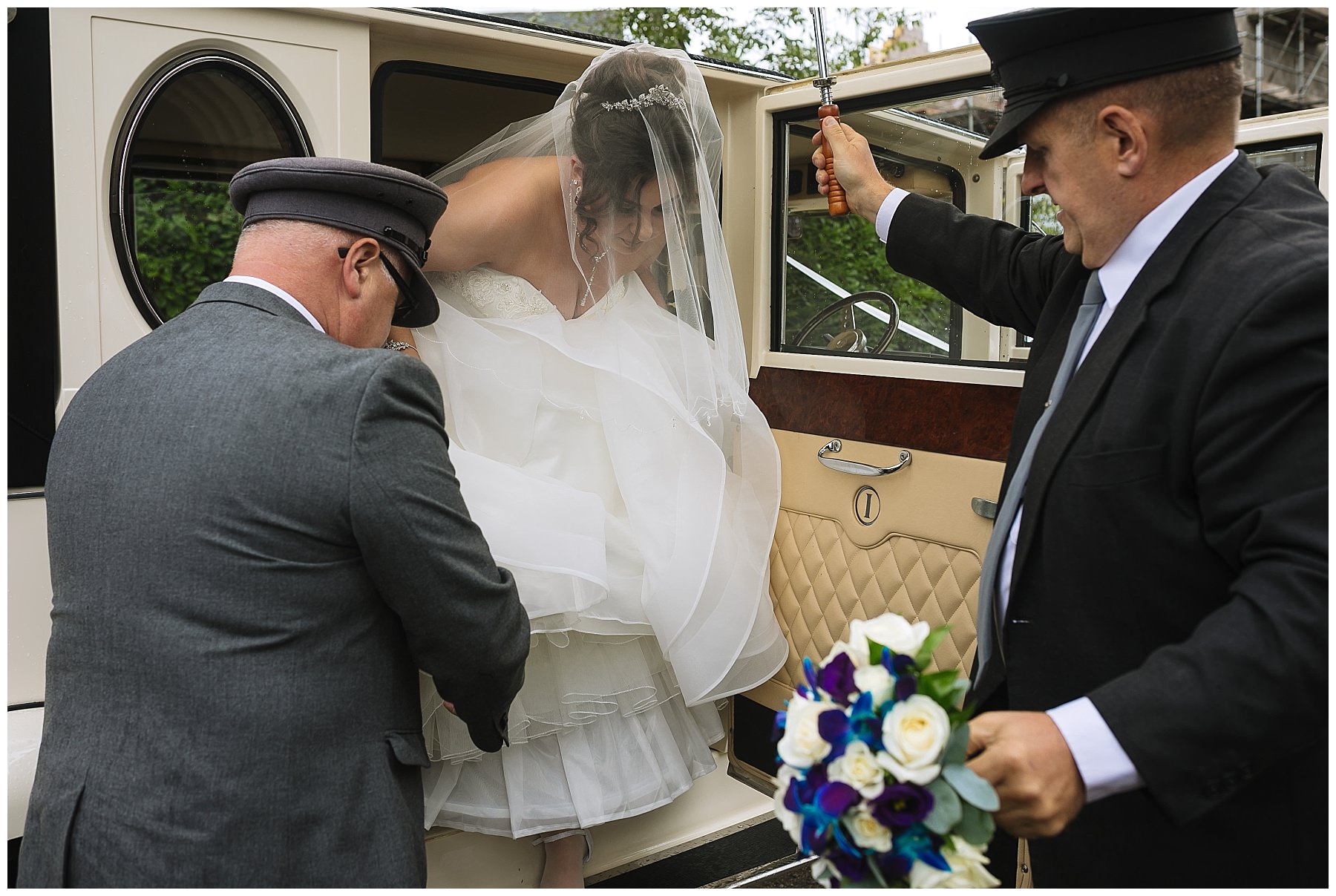 bride arrives at church in classic wedding car