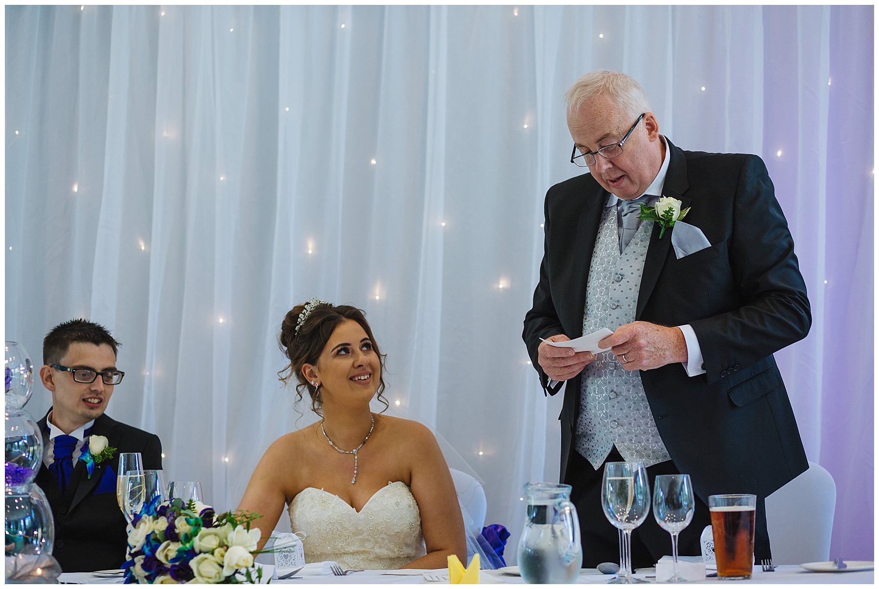 bride looks at father as he gives his speech