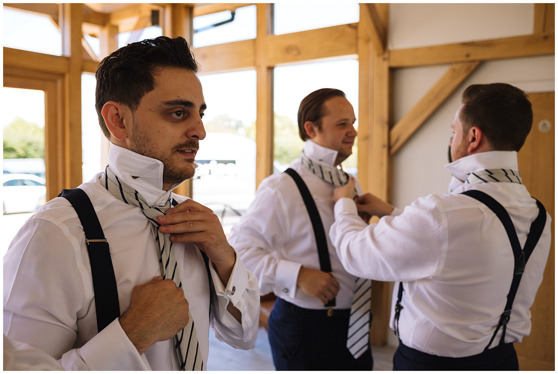 Groom and groomsmen fix their ties before wedding ceremony