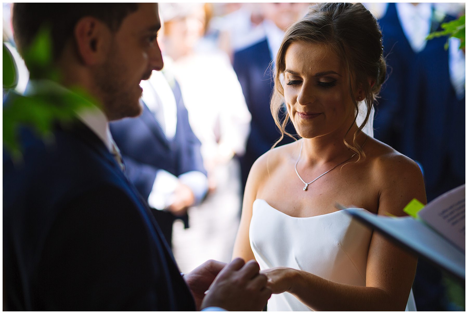 Exchange of rings at outdoor summer ceremony