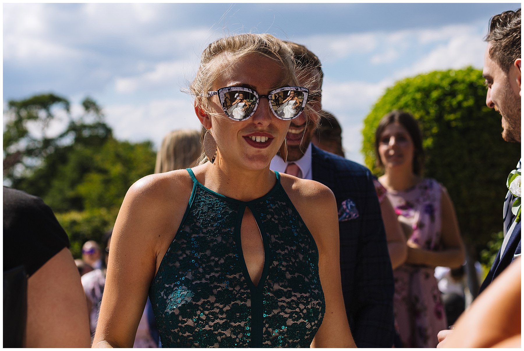 Bride reflected in guests sun glasses