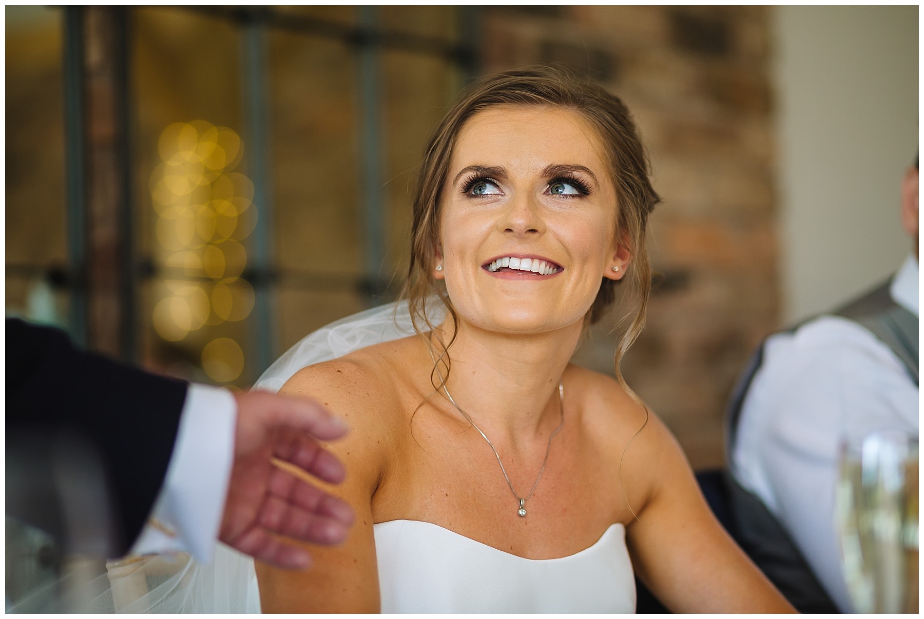 Bride looks on as her dad gives a speech