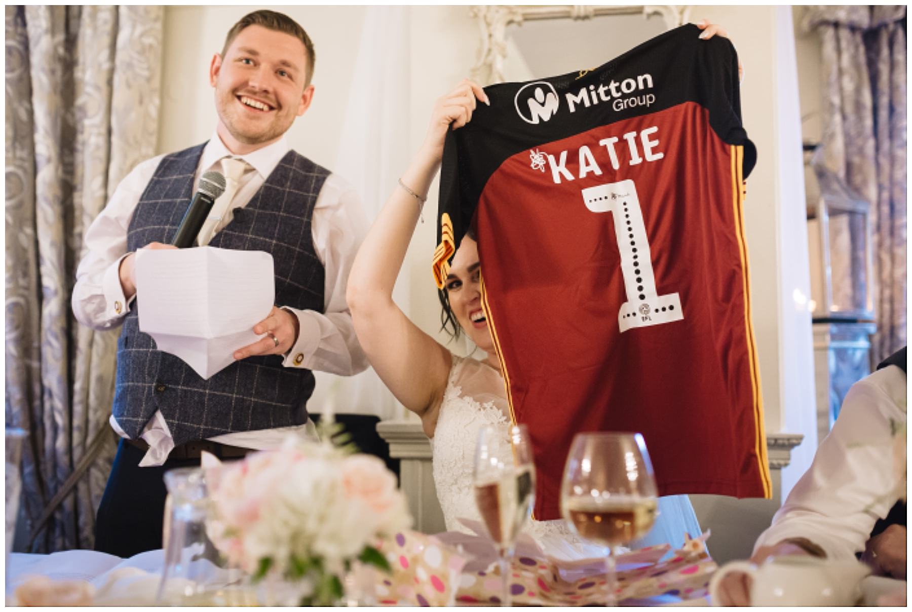 bride holds up football shirt presented as wedding gift