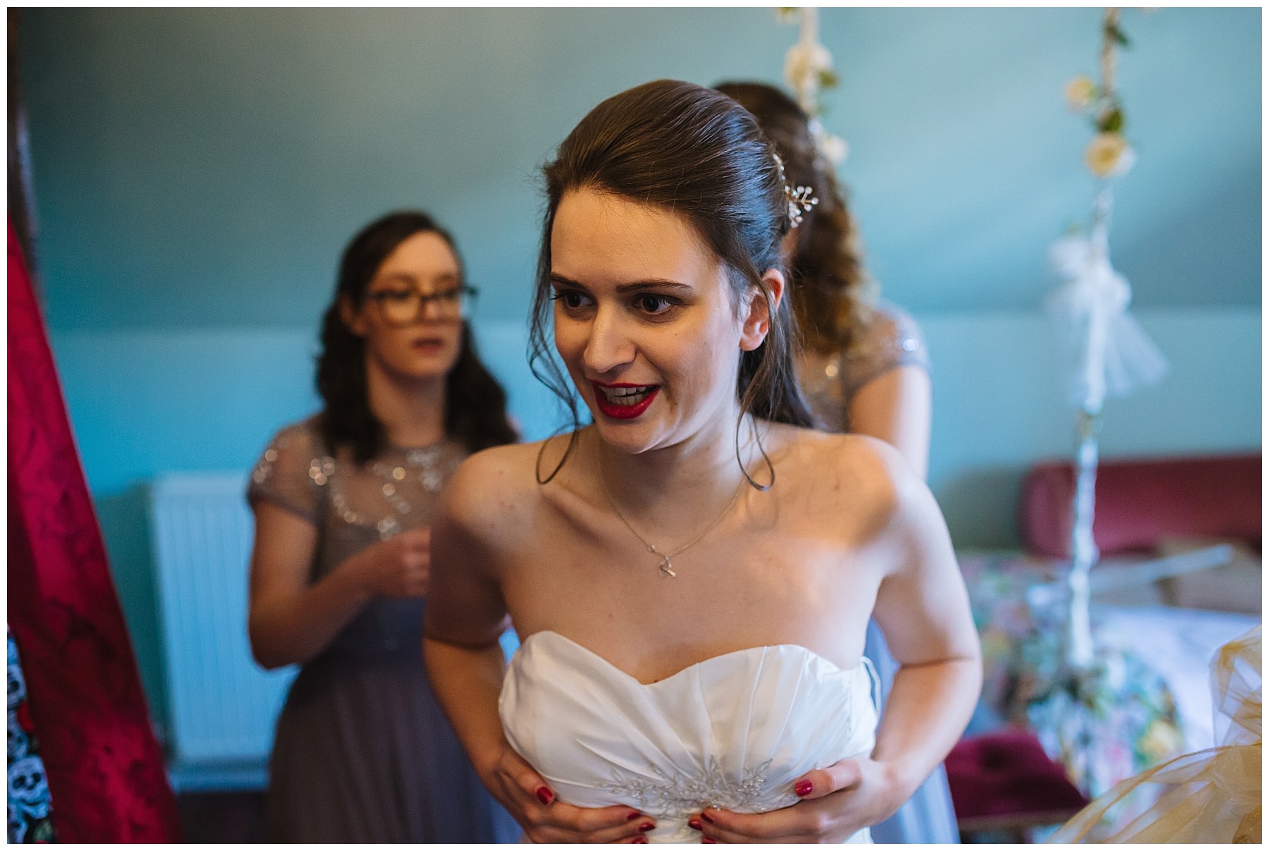 Bride puts on wedding dress at Hundred House Hotel